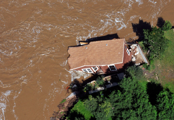 House falling into flood